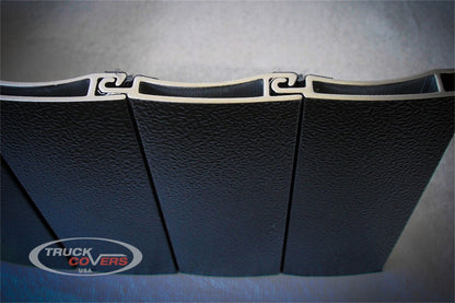 Black textured powder coated aluminum tonneau cover from Truck Covers USA part number CR142